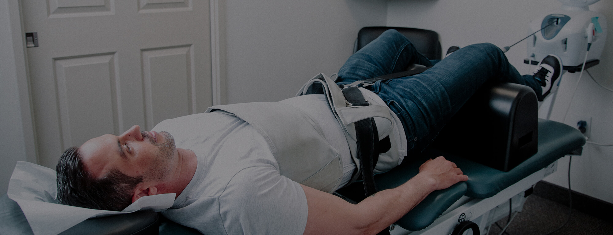 A male patient lying on his back while he receives spinal decompression therapy at Day Chiropractic.